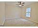 Neutral bedroom with a ceiling fan, large window, and plush carpeting at 212 Bella Rosa, Peachtree City, GA 30269
