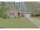 Charming single-story home featuring a well-manicured lawn and cozy curb appeal at 212 Bella Rosa, Peachtree City, GA 30269