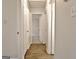 Hallway with hardwood flooring and a view of a bedroom, creating a welcoming passage at 212 Bella Rosa, Peachtree City, GA 30269