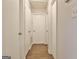 Hallway with many doors and hardwood flooring, leading to various rooms at 212 Bella Rosa, Peachtree City, GA 30269