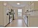 Well-lit kitchen with granite countertops, stainless steel appliances, and ample storage at 212 Bella Rosa, Peachtree City, GA 30269