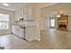 Open-concept kitchen and living room with stone fireplace and hardwood flooring at 212 Bella Rosa, Peachtree City, GA 30269