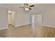 Open concept living room boasts wood grain floors and a ceiling fan for a modern feel at 212 Bella Rosa, Peachtree City, GA 30269