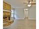 Living room featuring a stone fireplace, ceiling fan, and wood grain floors, a cozy gathering space at 212 Bella Rosa, Peachtree City, GA 30269