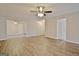 Expansive living room features new flooring and a ceiling fan at 212 Bella Rosa, Peachtree City, GA 30269