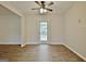 Bright room with hardwood flooring, a ceiling fan, and a glass-paneled door at 212 Bella Rosa, Peachtree City, GA 30269