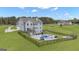 Aerial view of gray two-story home with pool, backyard and surrounding greenery at 176 Butler Rd, Brooks, GA 30205