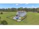 Expansive backyard featuring a fenced pool area, patio, fire pit, and lush green space at 176 Butler Rd, Brooks, GA 30205