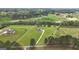 Aerial view of a beautiful home with 7 acres of land and a long driveway at 176 Butler Rd, Brooks, GA 30205