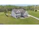 Aerial view of gray two-story home with landscaped yard, pool, and fire pit area at 176 Butler Rd, Brooks, GA 30205