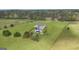 Aerial view of backyard with in-ground pool, lounge, fire pit, and expansive fenced yard at 176 Butler Rd, Brooks, GA 30205