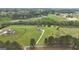 Aerial view of home on expansive green lot with mature trees and surrounding neighborhood at 176 Butler Rd, Brooks, GA 30205