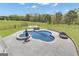Aerial view of a backyard featuring a large swimming pool and firepit at 176 Butler Rd, Brooks, GA 30205