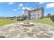 Landscaped backyard with in-ground pool, lounge area, and outdoor firepit at 176 Butler Rd, Brooks, GA 30205