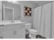 Bathroom with white vanity, modern sink faucet, and decorative tic-tac-toe toilet paper storage at 176 Butler Rd, Brooks, GA 30205