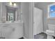 Well-lit bathroom with white vanity, mirror, and shower-tub combination at 176 Butler Rd, Brooks, GA 30205