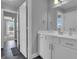 Bathroom boasts a white vanity with a large mirror and an open doorway leading to the bright bedroom at 176 Butler Rd, Brooks, GA 30205