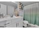 Bright bathroom features a white vanity and a toilet under a tic tac toe wall decoration at 176 Butler Rd, Brooks, GA 30205