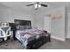 Bedroom features a dark wood bed, a ceiling fan, neutral walls, and views through the window at 176 Butler Rd, Brooks, GA 30205
