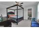 Bedroom features a four-poster bed, a ceiling fan, and access to an ensuite bathroom at 176 Butler Rd, Brooks, GA 30205