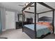 Bedroom showcasing a dark wood four-poster bed, light gray walls, and carpeted floors at 176 Butler Rd, Brooks, GA 30205