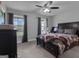 Bedroom showcases a dark wood bed, complemented by large windows that invite ample natural light and scenic outdoor views at 176 Butler Rd, Brooks, GA 30205