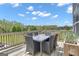 Relax on the outdoor deck with a table set and lovely view at 176 Butler Rd, Brooks, GA 30205