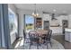 Dining room features a wooden table, pendant lighting, and large windows overlooking the green yard at 176 Butler Rd, Brooks, GA 30205