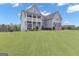Beautiful two-story home with lush green lawn and an inviting front porch at 176 Butler Rd, Brooks, GA 30205