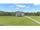 Two-story home with large front yard and long driveway leading to the house at 176 Butler Rd, Brooks, GA 30205