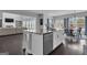 Open concept kitchen showcases a large island with seating that connects to the dining and living area at 176 Butler Rd, Brooks, GA 30205