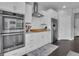 Bright kitchen features stainless steel appliances and white cabinets, offering a clean and modern aesthetic at 176 Butler Rd, Brooks, GA 30205