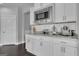 The kitchen features white cabinets, granite countertops, stainless appliances and a subway tile backsplash at 176 Butler Rd, Brooks, GA 30205