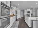 Spacious kitchen features white cabinets, stainless steel appliances and dark wood flooring at 176 Butler Rd, Brooks, GA 30205