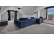 Upstairs living room with a large blue couch, tv, and natural light at 176 Butler Rd, Brooks, GA 30205