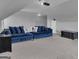 Upstairs living room with a large blue couch, side table, and pillows at 176 Butler Rd, Brooks, GA 30205