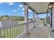 Covered porch presents a scenic view with white columns, a railing, and a green lawn beyond at 176 Butler Rd, Brooks, GA 30205