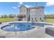 In-ground swimming pool with stone surround and outdoor lounge area located in backyard of home at 176 Butler Rd, Brooks, GA 30205