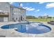 In-ground swimming pool and hot tub with backyard seating and view of the home's exterior at 176 Butler Rd, Brooks, GA 30205