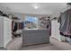 Walk-in closet with multiple storage shelves, hanging rods, and center island drawer unit at 176 Butler Rd, Brooks, GA 30205