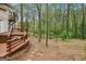 Inviting wooden deck extending into the backyard, with lush trees creating a serene outdoor space at 5296 Golfcrest Cir, Stone Mountain, GA 30088
