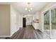 Spacious dining room and kitchen with dark hardwood floors and white cabinets at 5296 Golfcrest Cir, Stone Mountain, GA 30088