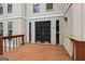 Spacious entryway with a wooden deck, features double doors and sidelight windows, blending indoor/outdoor living seamlessly at 5296 Golfcrest Cir, Stone Mountain, GA 30088