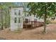 Rear exterior of a multi-story home with a wooden deck and multiple windows at 5296 Golfcrest Cir, Stone Mountain, GA 30088