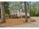Charming two-story home with a wooden deck, lush landscaping, and a quaint, cozy feel nestled among the trees at 5296 Golfcrest Cir, Stone Mountain, GA 30088
