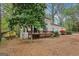 Two-story home with a wooden deck surrounded by mature trees, blending charm with natural beauty in a serene setting at 5296 Golfcrest Cir, Stone Mountain, GA 30088