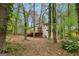 Tan home exterior showcasing a spacious wooden deck nestled among mature trees and natural beauty at 5296 Golfcrest Cir, Stone Mountain, GA 30088