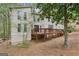 Rear exterior of home with wooden deck and natural landscaping at 5296 Golfcrest Cir, Stone Mountain, GA 30088