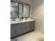 Bathroom features dual sinks, gray cabinets, white counters, and tile floors at 1751 S Olympian Way, Atlanta, GA 30310