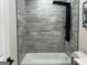 Bathroom featuring a new tub, shower head, and stylish tiles at 1751 S Olympian Way, Atlanta, GA 30310